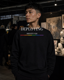 FÆBRIQ Deploying Identity v2.0 Heavyweight Crewneck — art-market lifestyle view showing the white chest print and six-stripe Pride Circuit bar.