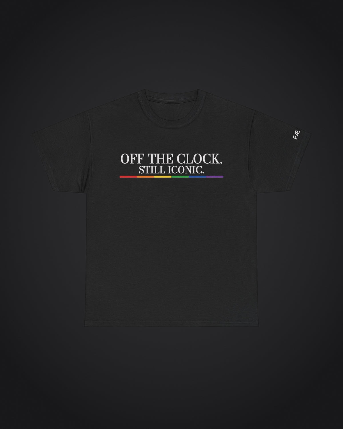 FÆBRIQ 'Off The Clock. Still Iconic.' Tee: black tee with the white Off The Clock. Still Iconic. print over the six-color pride-circuit bar, on a charcoal studio backdrop.